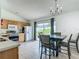 Bright dining area with sliding glass doors to the backyard and a chandelier at 5125 Pine Needle Dr, Mascotte, FL 34753