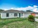 Inviting exterior featuring a well-manicured front yard, attached garage, and stylish architecture at 5125 Pine Needle Dr, Mascotte, FL 34753