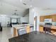 Open concept kitchen with bar seating overlooking the adjacent living room at 5125 Pine Needle Dr, Mascotte, FL 34753