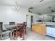 Eat-in kitchen featuring tile flooring, wooden cabinets, and modern appliances at 5125 Pine Needle Dr, Mascotte, FL 34753