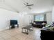 Spacious living room with tile flooring, ceiling fan, and natural light, ideal for relaxation and entertainment at 5125 Pine Needle Dr, Mascotte, FL 34753
