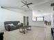 Bright living room with tile flooring, a ceiling fan, and plenty of space for relaxation and entertaining at 5125 Pine Needle Dr, Mascotte, FL 34753