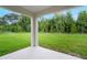 Spacious backyard with lush green lawn and sprinkler system surrounded by mature trees at 5162 Masser Rd, St Cloud, FL 34772