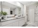 Well-lit bathroom featuring double sinks, granite countertops, and walk-in shower at 5162 Masser Rd, St Cloud, FL 34772