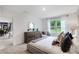 Bright bedroom featuring neutral decor, a large window, and modern furnishings at 5162 Masser Rd, St Cloud, FL 34772