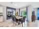 Elegant dining room with a wooden table, seating for six, stylish decor, and sliding glass doors at 5162 Masser Rd, St Cloud, FL 34772