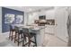 Stylish kitchen with a granite island, stainless steel appliances, white cabinetry, and barstool seating for four at 5162 Masser Rd, St Cloud, FL 34772