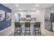 Modern kitchen featuring stainless steel appliances, a granite countertop island with seating, and white cabinetry at 5162 Masser Rd, St Cloud, FL 34772