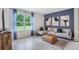 Cozy living room with a comfortable sectional sofa, an ottoman, and a window overlooking the backyard at 5162 Masser Rd, St Cloud, FL 34772