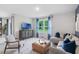 Bright living room featuring a comfortable seating arrangement and a large window with natural lighting at 5162 Masser Rd, St Cloud, FL 34772