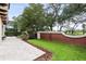 Well-manicured backyard with a serene water feature, lush lawn, and brick privacy wall at 617 Canopy Estates Dr, Winter Garden, FL 34787
