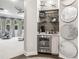 Entertainment area featuring custom shelving, beverage refrigerator, and decorative accents at 617 Canopy Estates Dr, Winter Garden, FL 34787