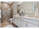 Bright bathroom features double sinks, a large mirror, and a glass enclosed shower at 617 Canopy Estates Dr, Winter Garden, FL 34787