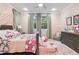 Charming bedroom with pink accents, playful decor, and natural lighting at 617 Canopy Estates Dr, Winter Garden, FL 34787
