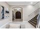 Inviting home entryway features an elegant double door, staircase, and sophisticated décor at 617 Canopy Estates Dr, Winter Garden, FL 34787