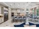 Modern kitchen features a large island with seating, stainless steel appliances, and a dining area at 617 Canopy Estates Dr, Winter Garden, FL 34787