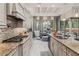 Well-designed kitchen features granite countertops, stainless steel appliances, and opens to a dining area at 617 Canopy Estates Dr, Winter Garden, FL 34787
