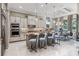 Bright, modern kitchen features a central island with seating, stainless steel appliances, and decorative lighting at 617 Canopy Estates Dr, Winter Garden, FL 34787