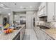 Bright kitchen features stainless steel appliances, granite countertops, and a stylish backsplash at 617 Canopy Estates Dr, Winter Garden, FL 34787