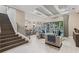 Bright open-concept home featuring a staircase and connecting the living room and kitchen with backyard views at 617 Canopy Estates Dr, Winter Garden, FL 34787