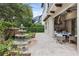 Outdoor patio with built in grill and a dining area, water feature and lush landscaping at 617 Canopy Estates Dr, Winter Garden, FL 34787
