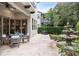 Outdoor patio with built in grill and a dining area, water feature and lush landscaping at 617 Canopy Estates Dr, Winter Garden, FL 34787
