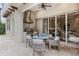 Outdoor patio with built in grill and a dining area, water feature and lush landscaping at 617 Canopy Estates Dr, Winter Garden, FL 34787