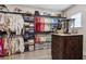 Spacious walk-in closet with custom shelving, ample storage, and hardwood flooring at 617 Canopy Estates Dr, Winter Garden, FL 34787