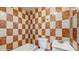 Bathroom features colorful checkered tiling, a toilet and a vanity sink at 624 American Heritage Pkwy, Orlando, FL 32809