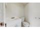 A clean bathroom with a white vanity, toilet, and neutral walls at 624 American Heritage Pkwy, Orlando, FL 32809