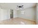 A bright bedroom featuring neutral walls, tile flooring, and a modern ceiling fan at 624 American Heritage Pkwy, Orlando, FL 32809