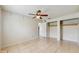 A bedroom featuring tile flooring, closet space, and neutral-colored walls at 624 American Heritage Pkwy, Orlando, FL 32809