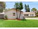 Charming single-story home with stone accents, a well-manicured lawn, and mature trees at 624 American Heritage Pkwy, Orlando, FL 32809