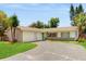 Single-story home with a driveway, a light exterior, and a well-manicured lawn at 624 American Heritage Pkwy, Orlando, FL 32809