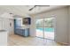 Functional kitchen with blue cabinets, tile floors, and sliding doors to the pool area at 624 American Heritage Pkwy, Orlando, FL 32809