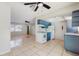 Bright kitchen featuring blue cabinets, white appliances, and tile flooring at 624 American Heritage Pkwy, Orlando, FL 32809