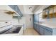 Functional kitchen with blue cabinets, tile floors, and essential appliances at 624 American Heritage Pkwy, Orlando, FL 32809