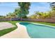 Backyard pool offers a refreshing escape with private fencing and surrounding greenery at 624 American Heritage Pkwy, Orlando, FL 32809