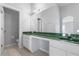 Bright bathroom with a white vanity and a green marble countertop at 631 Lady Diana Dr, Davenport, FL 33837