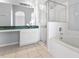 Bright bathroom featuring a glass enclosed shower and bathtub combination at 631 Lady Diana Dr, Davenport, FL 33837