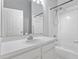 Clean bathroom featuring a white vanity, shower with tub and tile surround at 631 Lady Diana Dr, Davenport, FL 33837