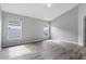 Bedroom with neutral paint, wood-look flooring, and two windows for natural light at 631 Lady Diana Dr, Davenport, FL 33837