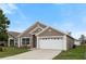Charming single-story home with a well-maintained lawn and a two-car garage in a sunny neighborhood at 631 Lady Diana Dr, Davenport, FL 33837