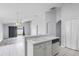 Bright eat-in kitchen with a double sink, white cabinetry, and a view of the living area at 631 Lady Diana Dr, Davenport, FL 33837