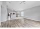 Spacious living room adjacent to kitchen featuring wood-look flooring and plenty of natural light at 631 Lady Diana Dr, Davenport, FL 33837
