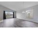 Bright living room featuring sleek gray floors, vaulted ceilings, a large window, and neutral paint at 631 Lady Diana Dr, Davenport, FL 33837