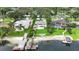 Expansive waterfront property boasts lush landscaping, private boat docks, and an inviting in-ground pool at 7145 Lake Dr, Orlando, FL 32809