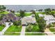 Aerial view showcases a home with a well-manicured lawn and tree shaded paved driveway at 7145 Lake Dr, Orlando, FL 32809