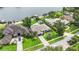 Aerial view displays houses with manicured lawns, mature trees, and access to the peaceful waterfront at 7145 Lake Dr, Orlando, FL 32809