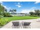 Waterfront backyard oasis with lush landscaping, a private dock, and comfortable lounge chairs, perfect for relaxation at 7145 Lake Dr, Orlando, FL 32809